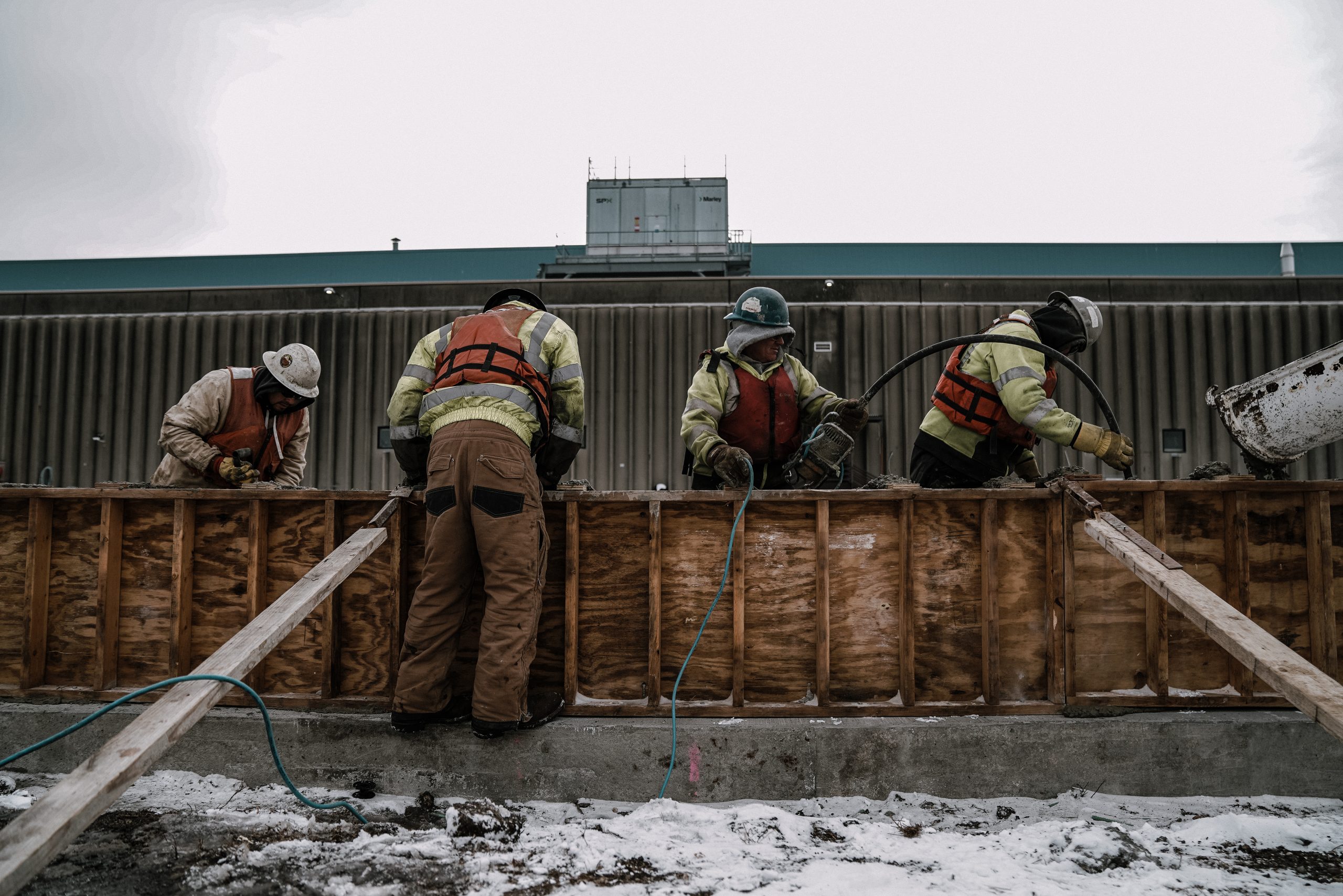 Workers pouring concrete on Dock Wall in Port Milwaukee