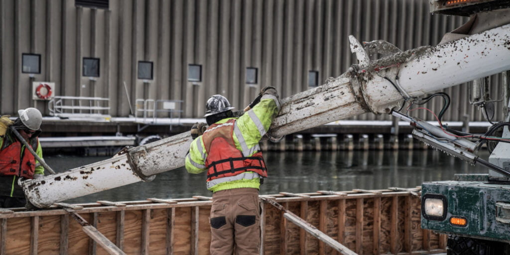 men pouring concrete