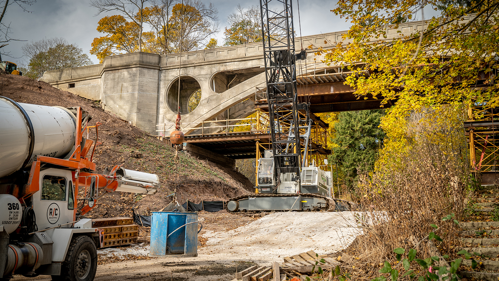 Wide shot view of crane in front of Lake Park Arch Bridge (Ravine Road Bridge)