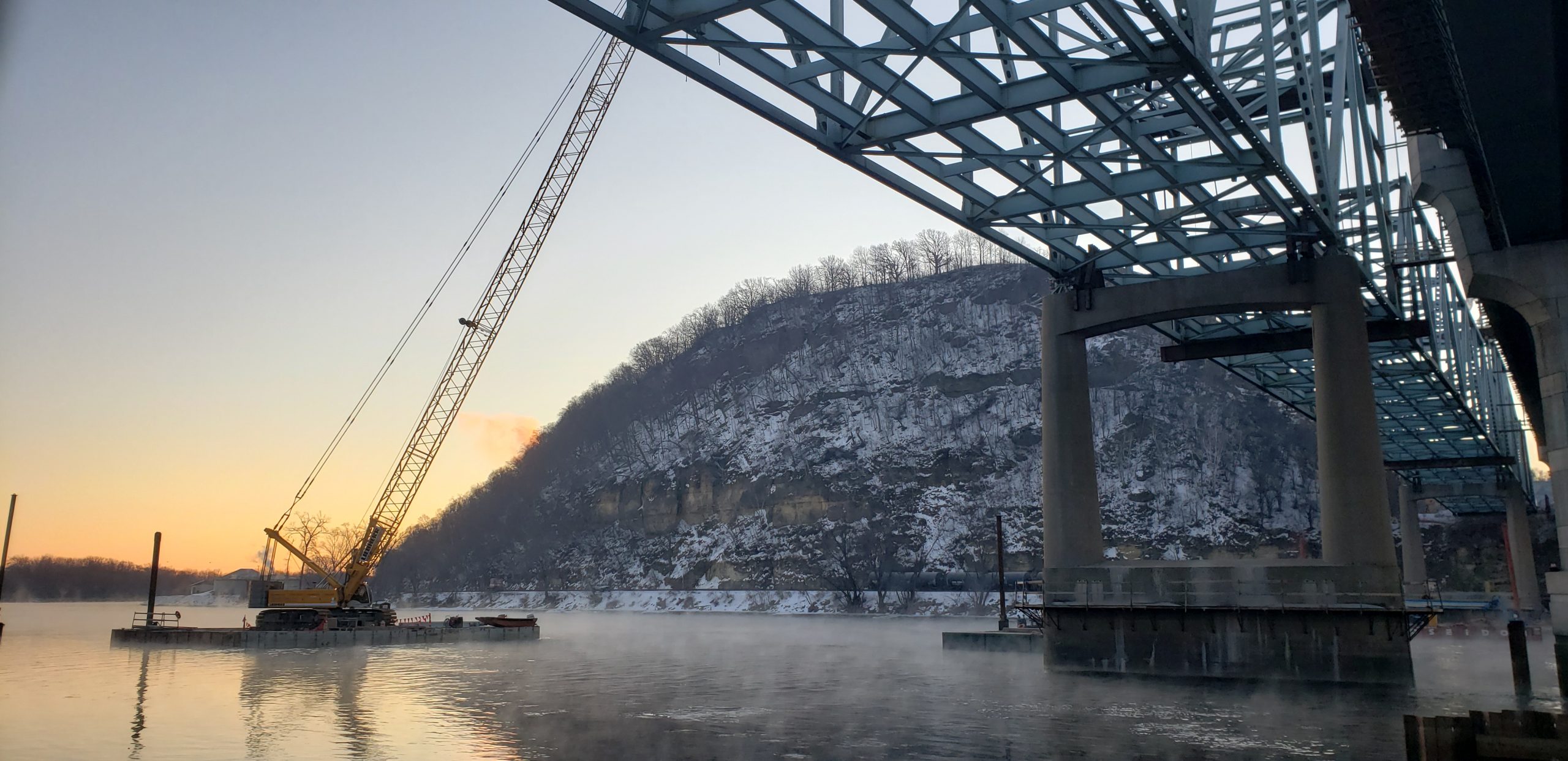 Wide shot view under Red Wing Eisenhower Bridge of valor, showcasing construction and infrastructure of the bridge
