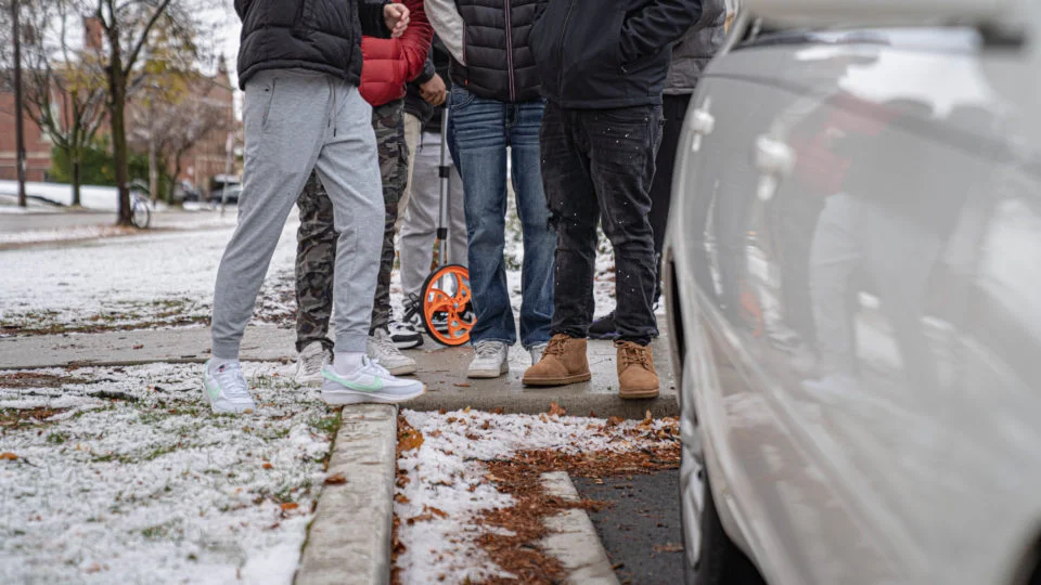 group of kids with surveying equipment