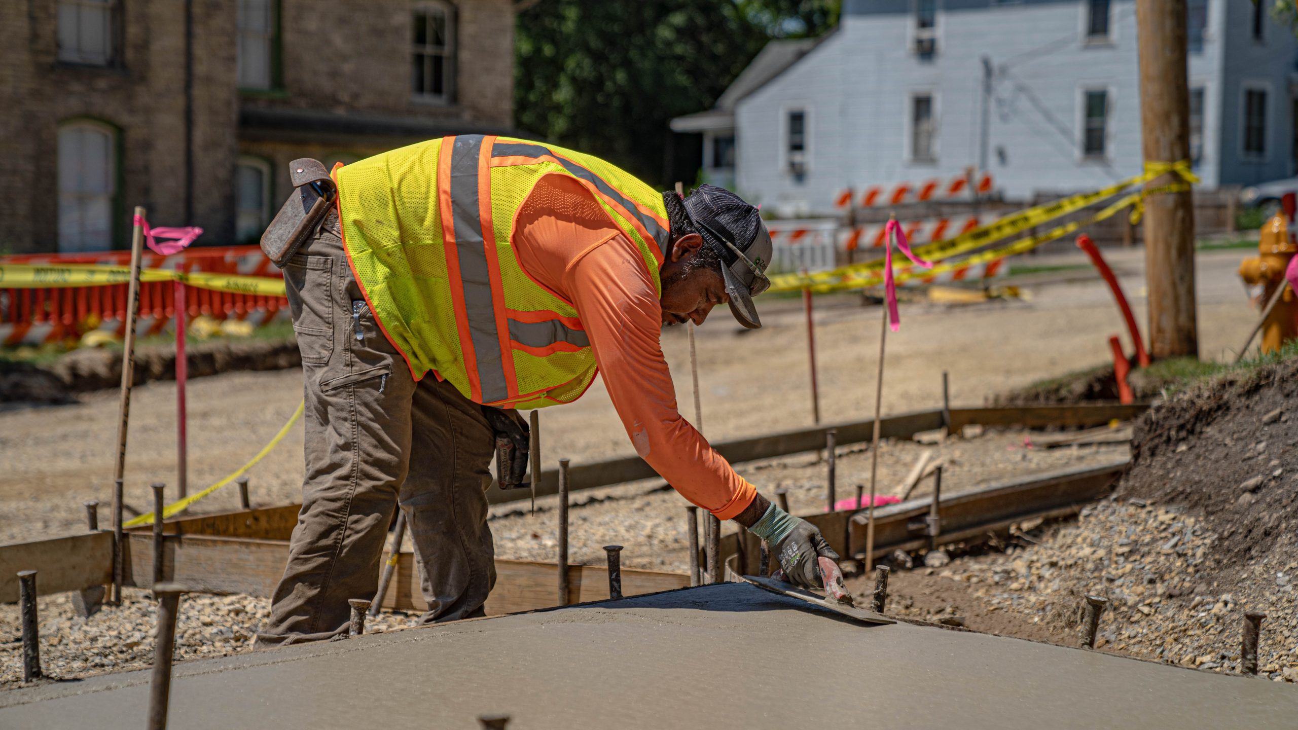 Close up of worker leveling concrete at East Milwaukee Street