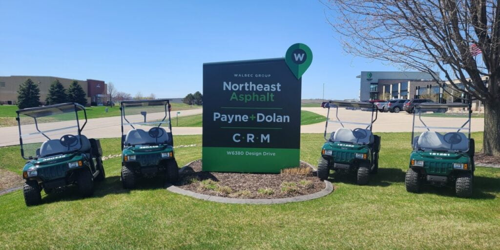 Northeast Asphalt, Payne and Dolan, and CRM sign with golf carts