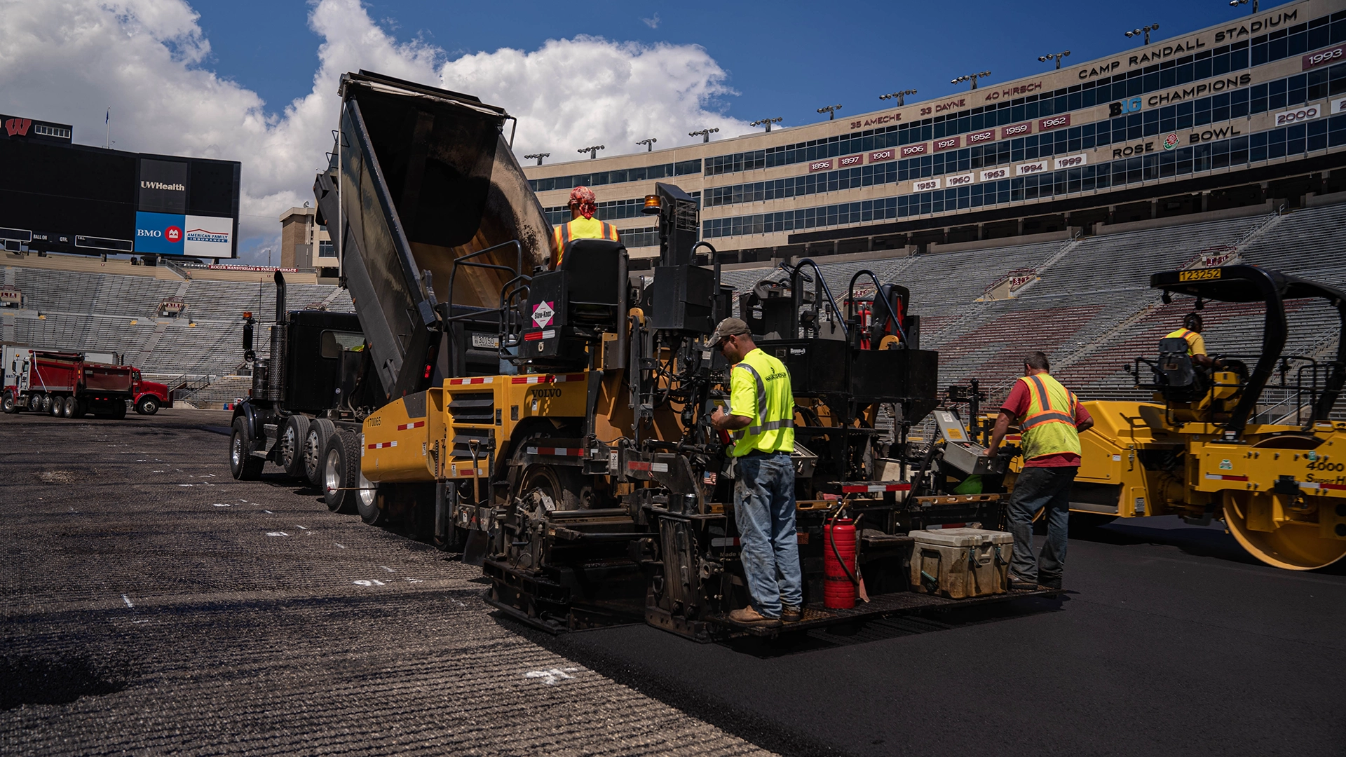 men with heavy equipment installing pavement