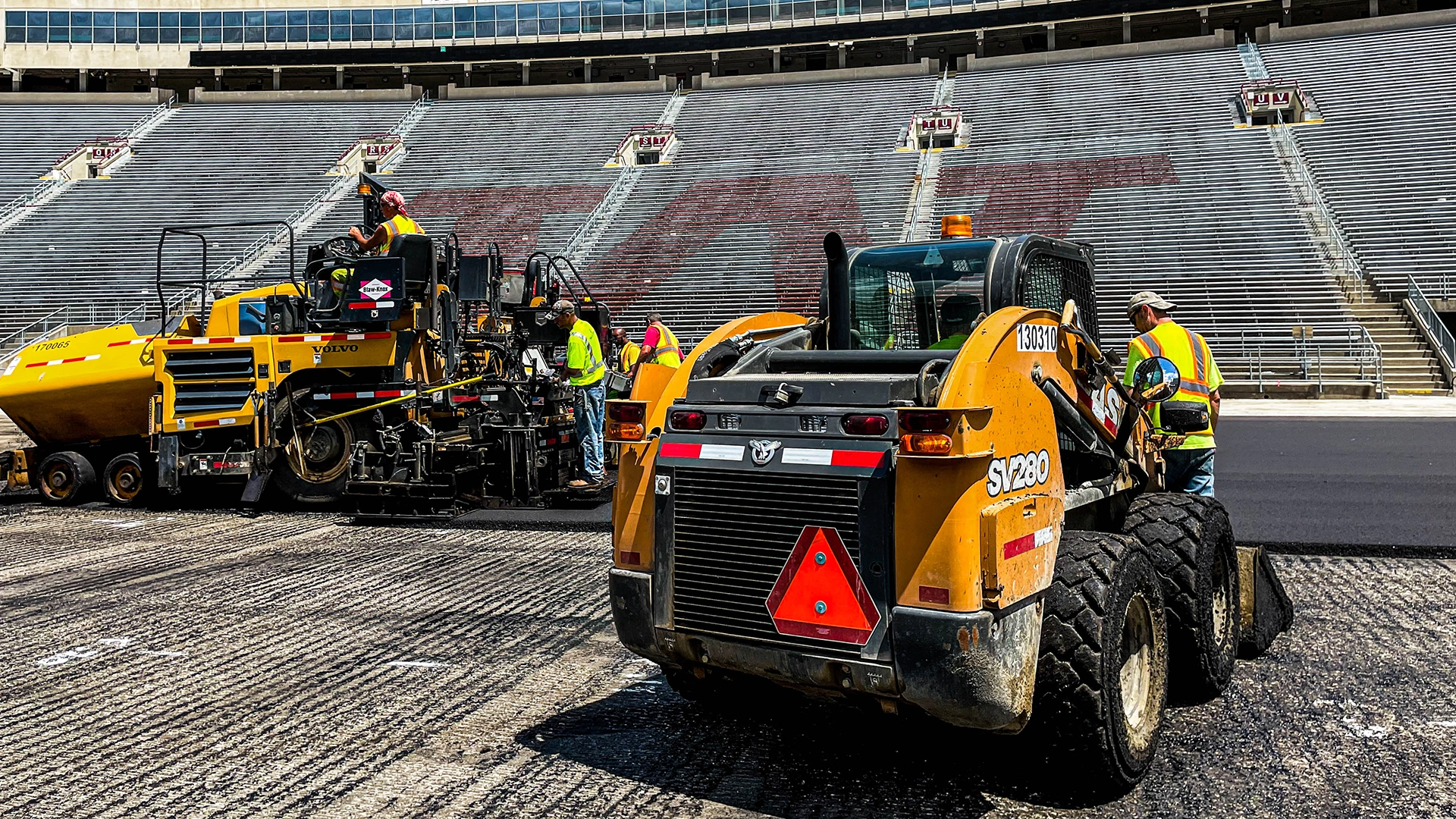 men with heavy equipment working on new turf
