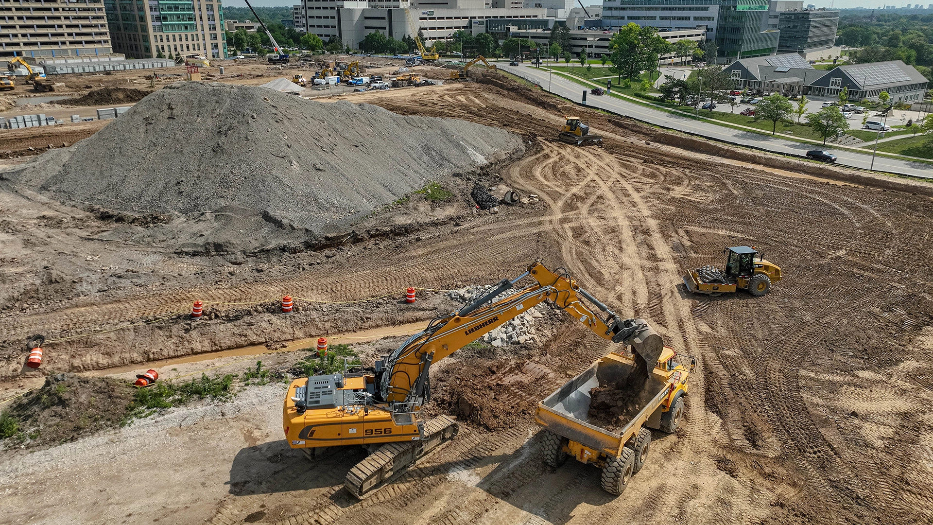 Excavator and dump truck moving dirt