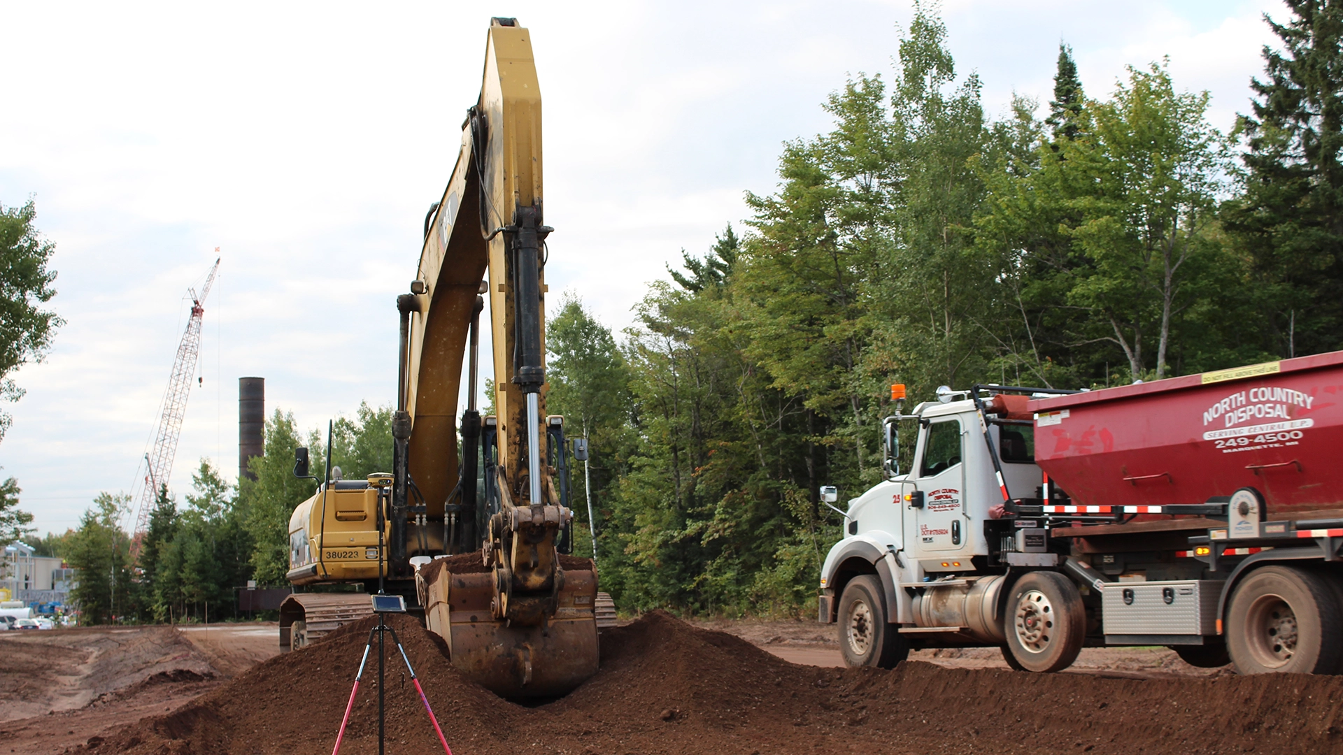Excavator and dump truck on jobsite