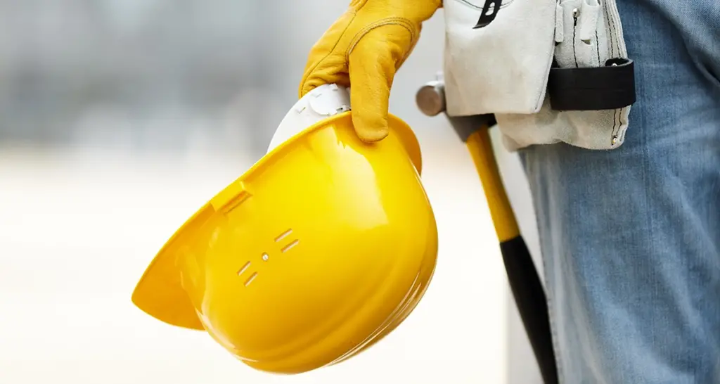 close up of person holding hard hat