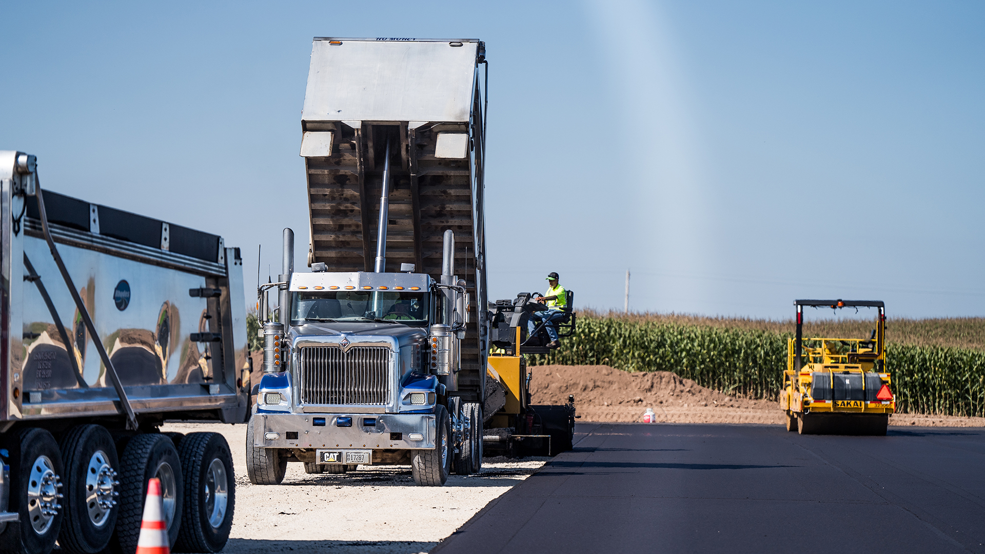 Close up of machinery applying and leveling asphalt at Sunny Slope Dairy